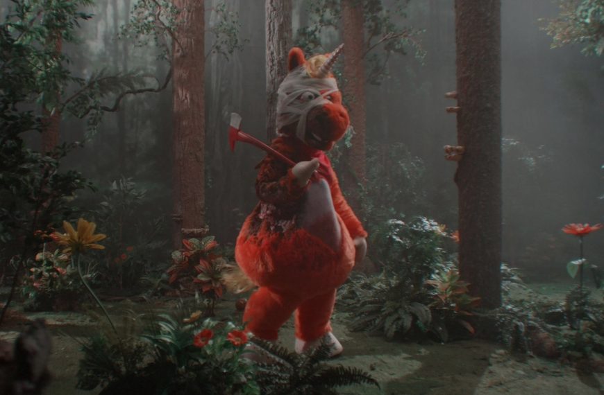 Bright orange unicorn Buddy from Casper Kelly’s 2026 horror comedy Buddy, which became a surprise indie box office hit with a $5.36 million opening weekend.